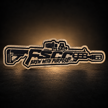 Load image into Gallery viewer, Detail of the FSCC Brew With Purpose leather rifle patch attached to the hat