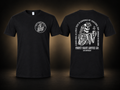 A Good Man Tee in Black, front and back views, black background with warm beige glow